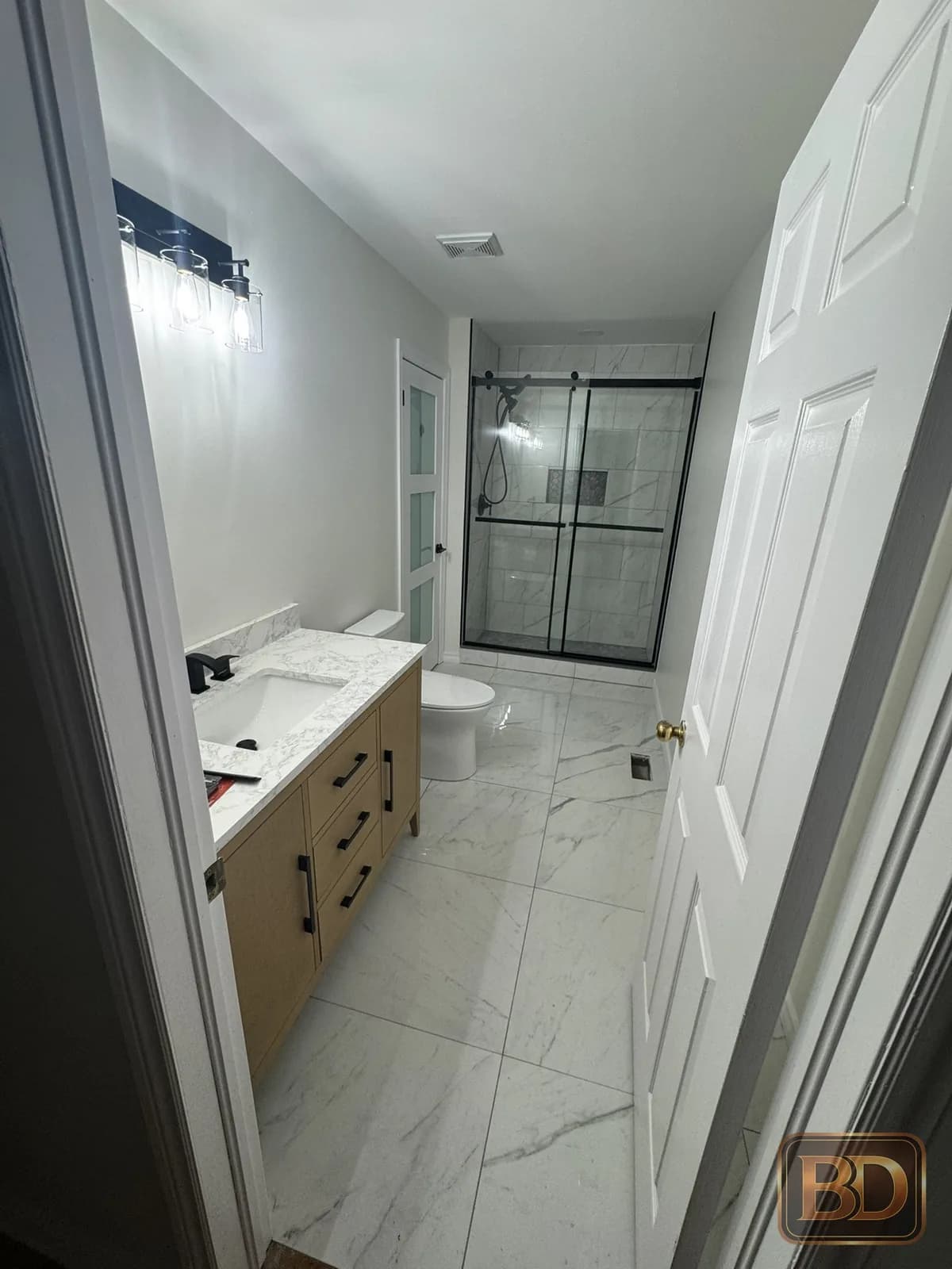 Completed bathroom renovation with tile and glass shower