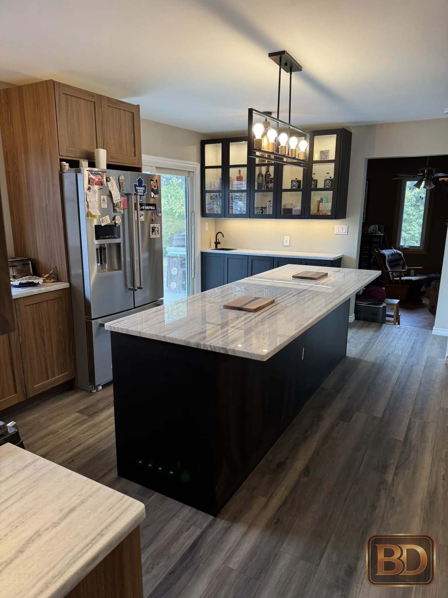 Renovated kitchen with an island and contrasting bar cabinetry